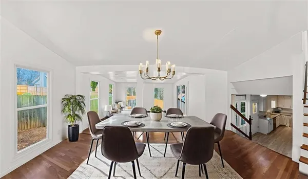 a view of a dining room with furniture wooden floor and chandelier