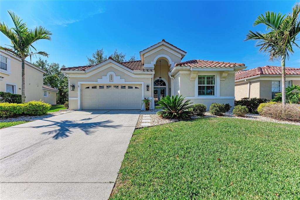 a front view of a house with a garden