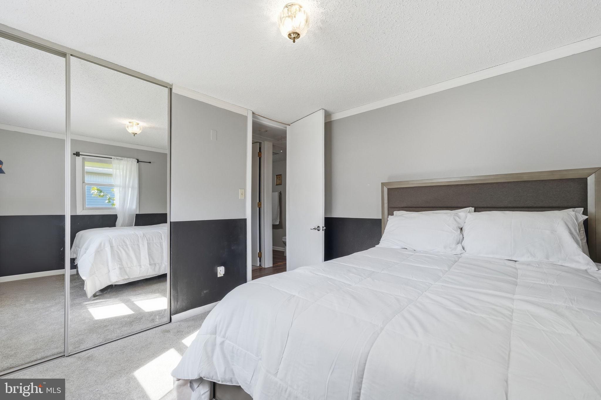 906 Wingfield Road Woodbridge, VA 22191 - Photo 22 of 31 Serene bedroom with mirrored elegance.