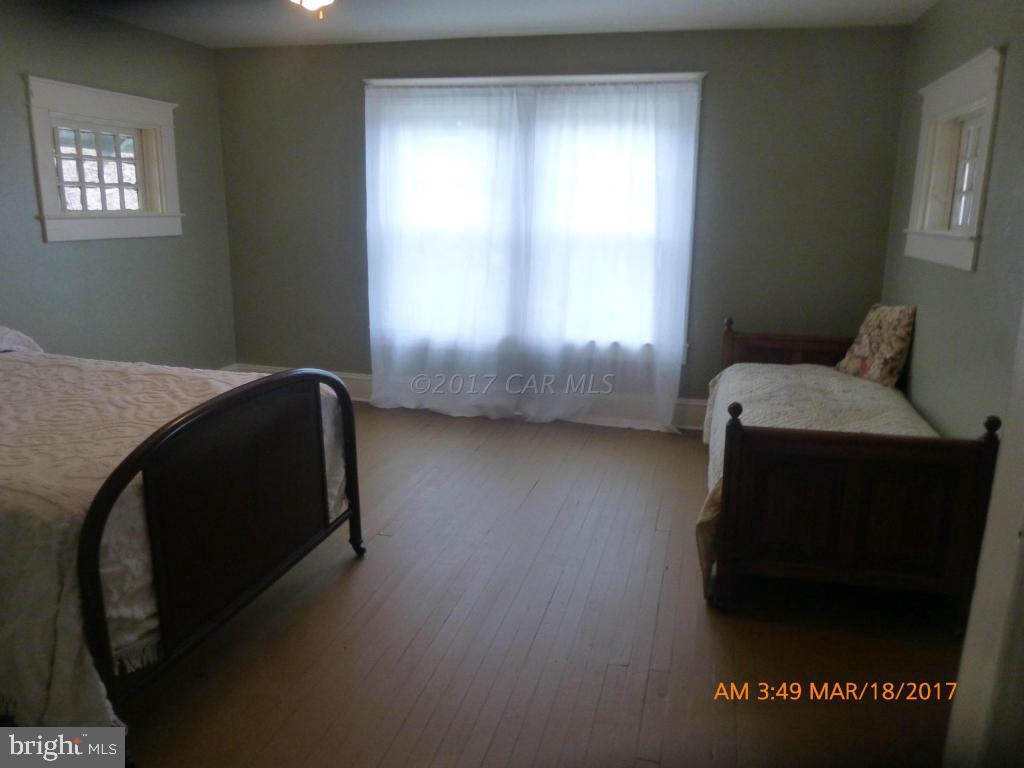 23468 Deal Island Road Deal Island, MD 21821 - Photo 11 of 20 a bedroom with a bed and a window