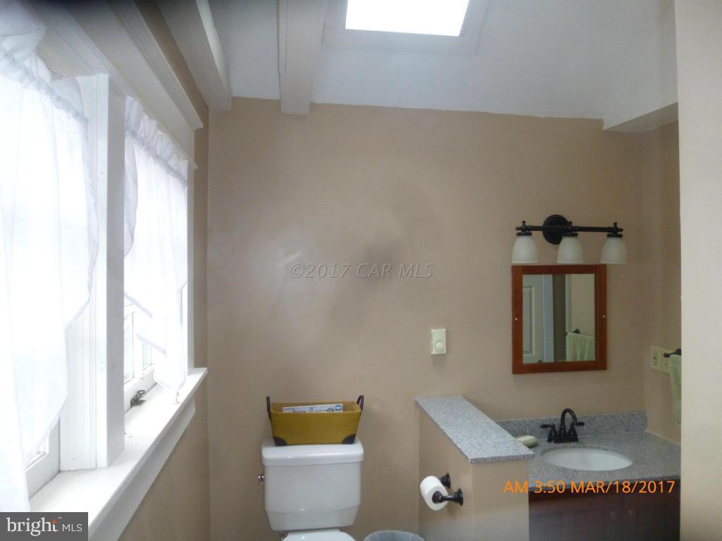23468 Deal Island Road Deal Island, MD 21821 - Photo 13 of 20 a bathroom with a bathtub a sink and a window