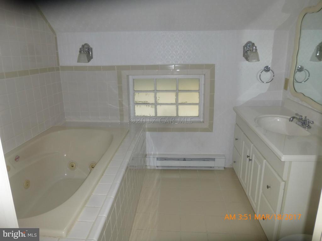23468 Deal Island Road Deal Island, MD 21821 - Photo 15 of 20 a bathroom with a tub sink and mirror