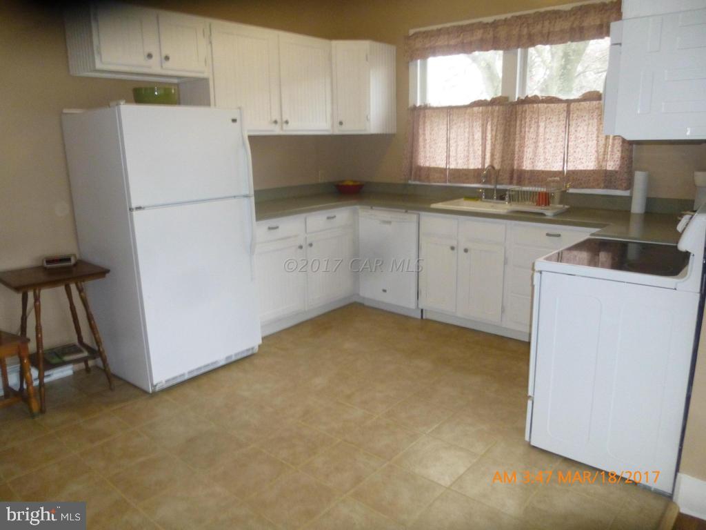 23468 Deal Island Road Deal Island, MD 21821 - Photo 7 of 20 a kitchen with cabinets appliances a sink and a window