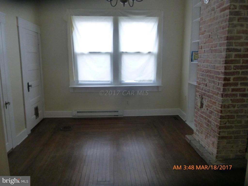 23468 Deal Island Road Deal Island, MD 21821 - Photo 9 of 20 an empty room with wooden floor and windows
