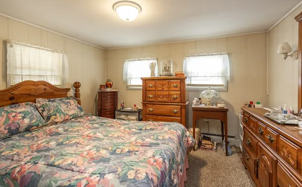 a bedroom with a bed and a dresser