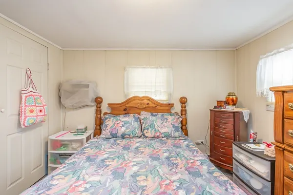 a bed room with a bed and a television