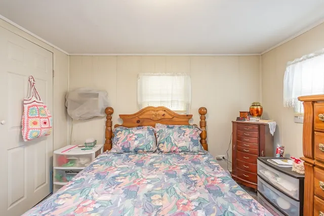 a bed room with a bed and a television