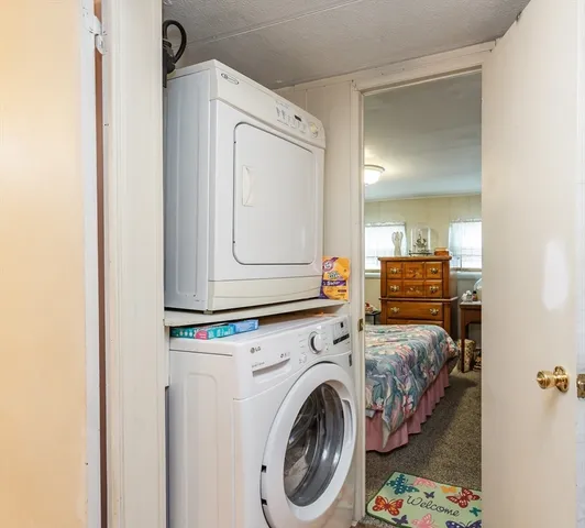 a view of a bedroom with washer and dryer