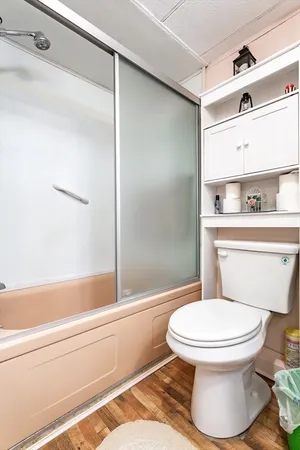 a bathroom with a toilet and a shower