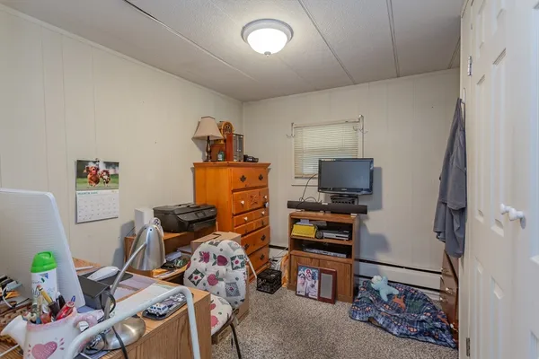 a bedroom with furniture and a window