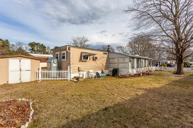 a view of a house with a yard covered in snow