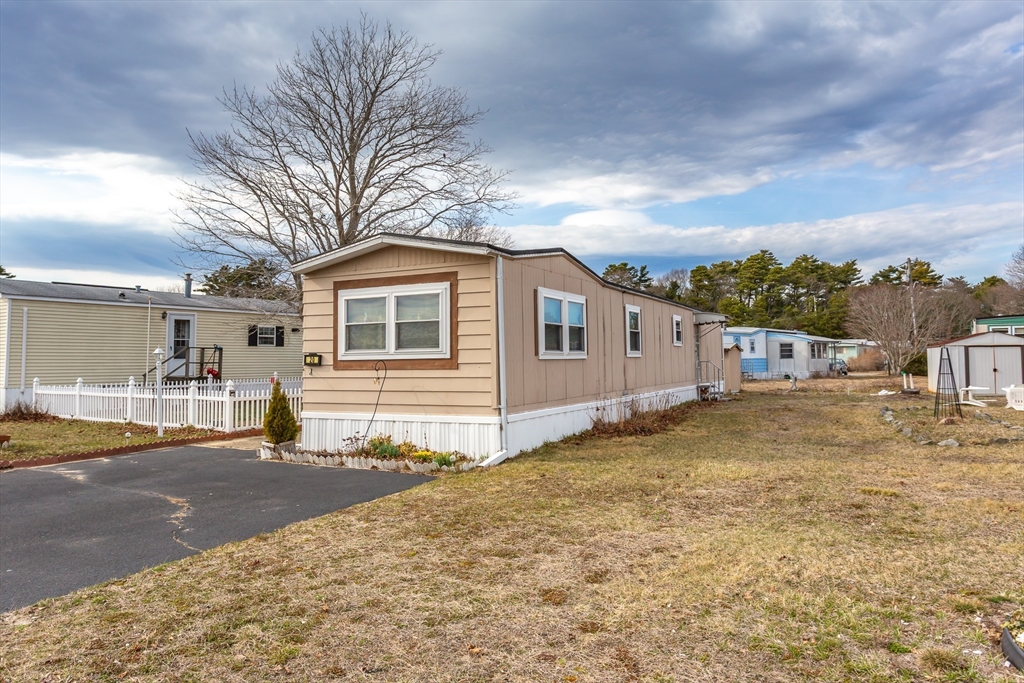 20 Madeline Street Wareham, MA 02538 - Photo 3 of 22 a front view of a house with a yard and garage