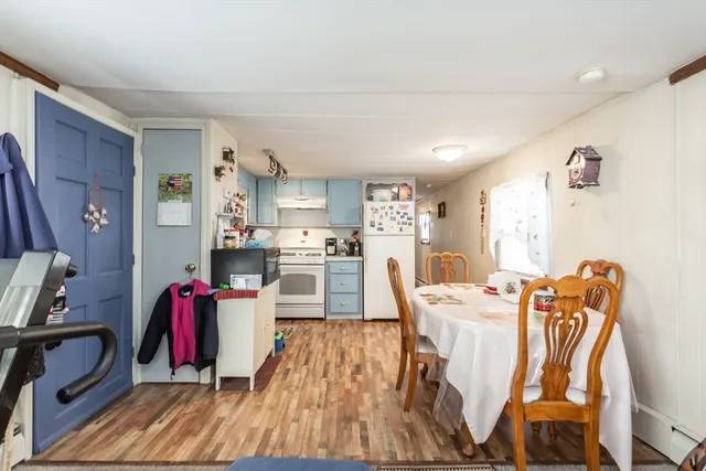 a living room with furniture a flat screen tv and a dining table