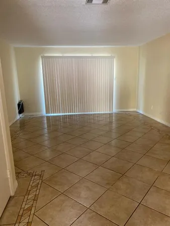 a view of an empty room with glass door