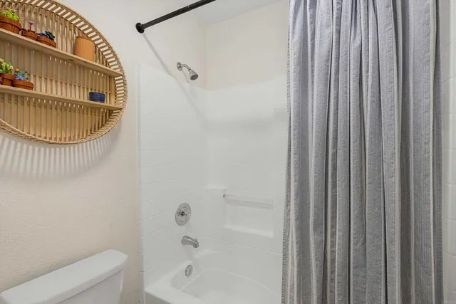 a bathroom with a toilet a sink and bathtub