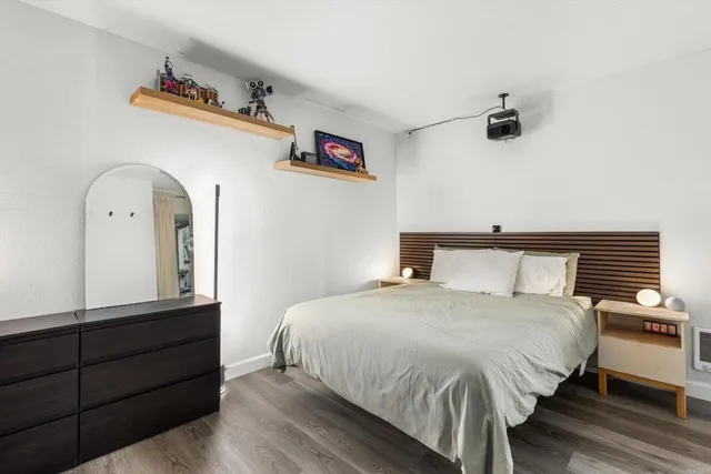 a bedroom with a bed and a dresser