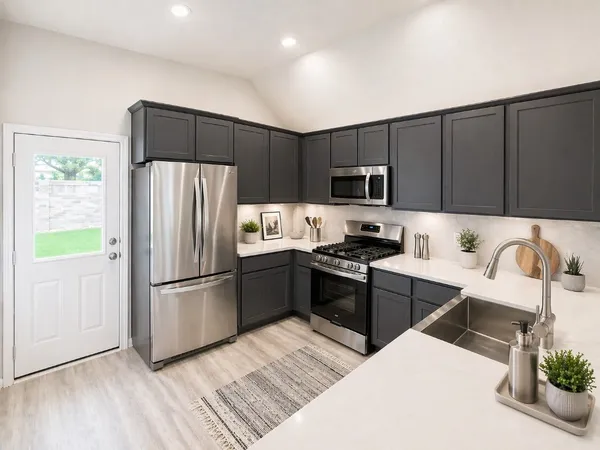 a kitchen with granite countertop a refrigerator stove top oven and sink