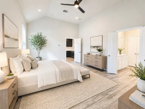 a bedroom with a bed and a chandelier