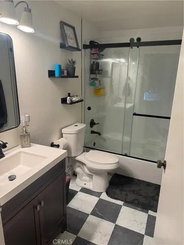 a bathroom with a toilet a sink and shower