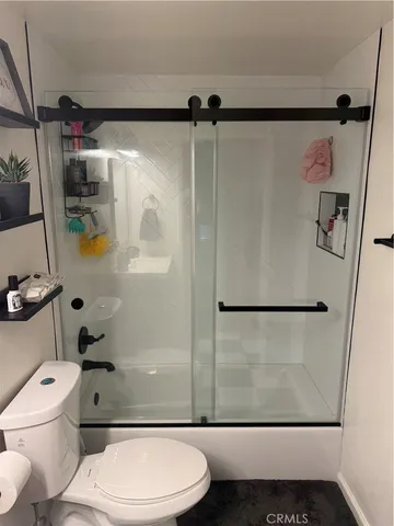 a bathroom with a toilet and a shower