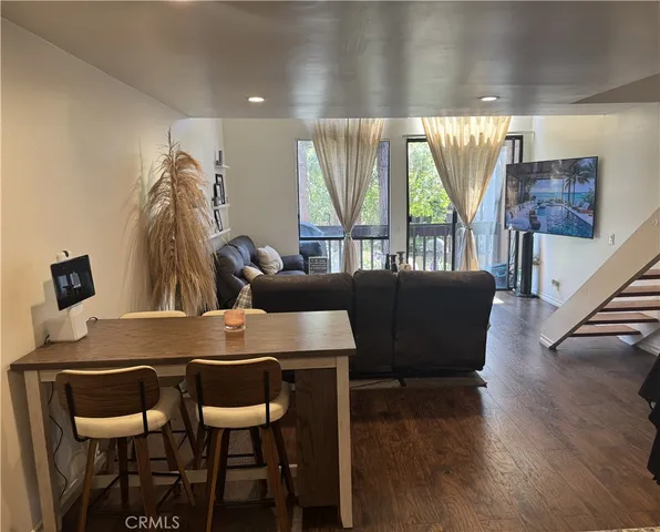 a view of a dining room with furniture and a large window