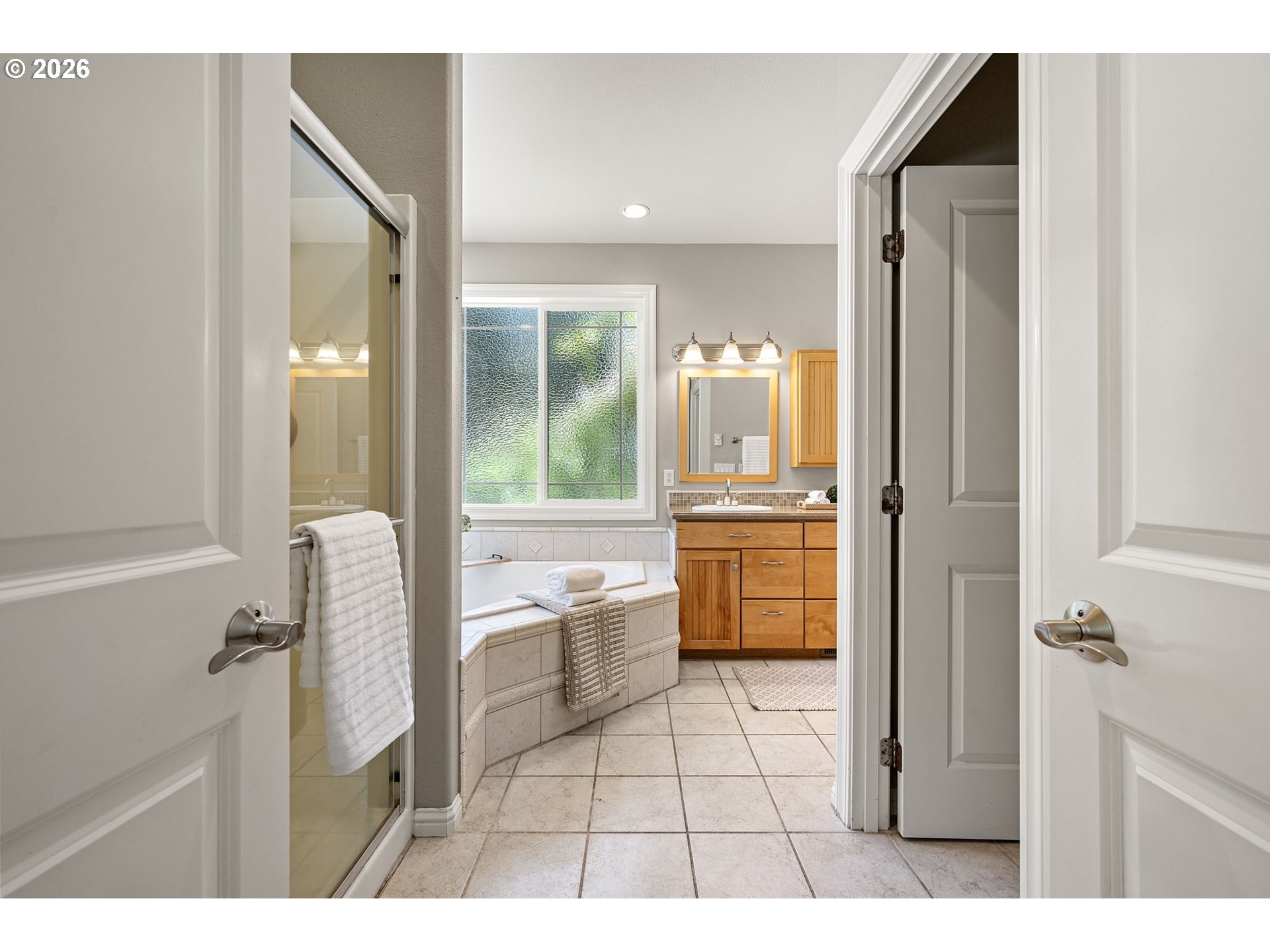 2218 Willow Loop Florence, OR 97439 - Photo 16 of 47 a bathroom with a granite countertop sink a mirror and a bathtub
