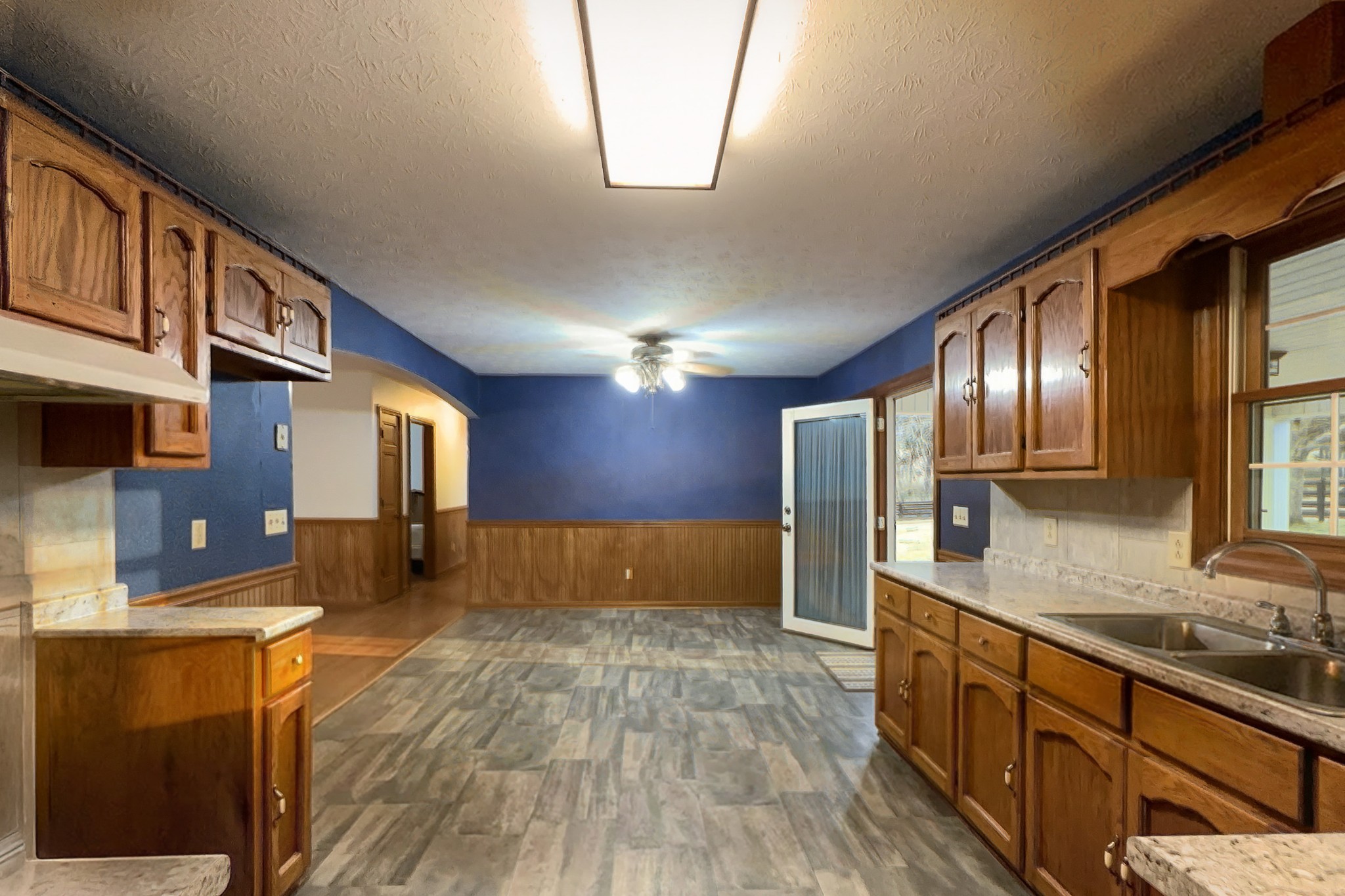 6680 Walker Creek Road Alexandria, TN 37012 - Photo 18 of 76 a large kitchen with stainless steel appliances granite countertop a sink and a refrigerator