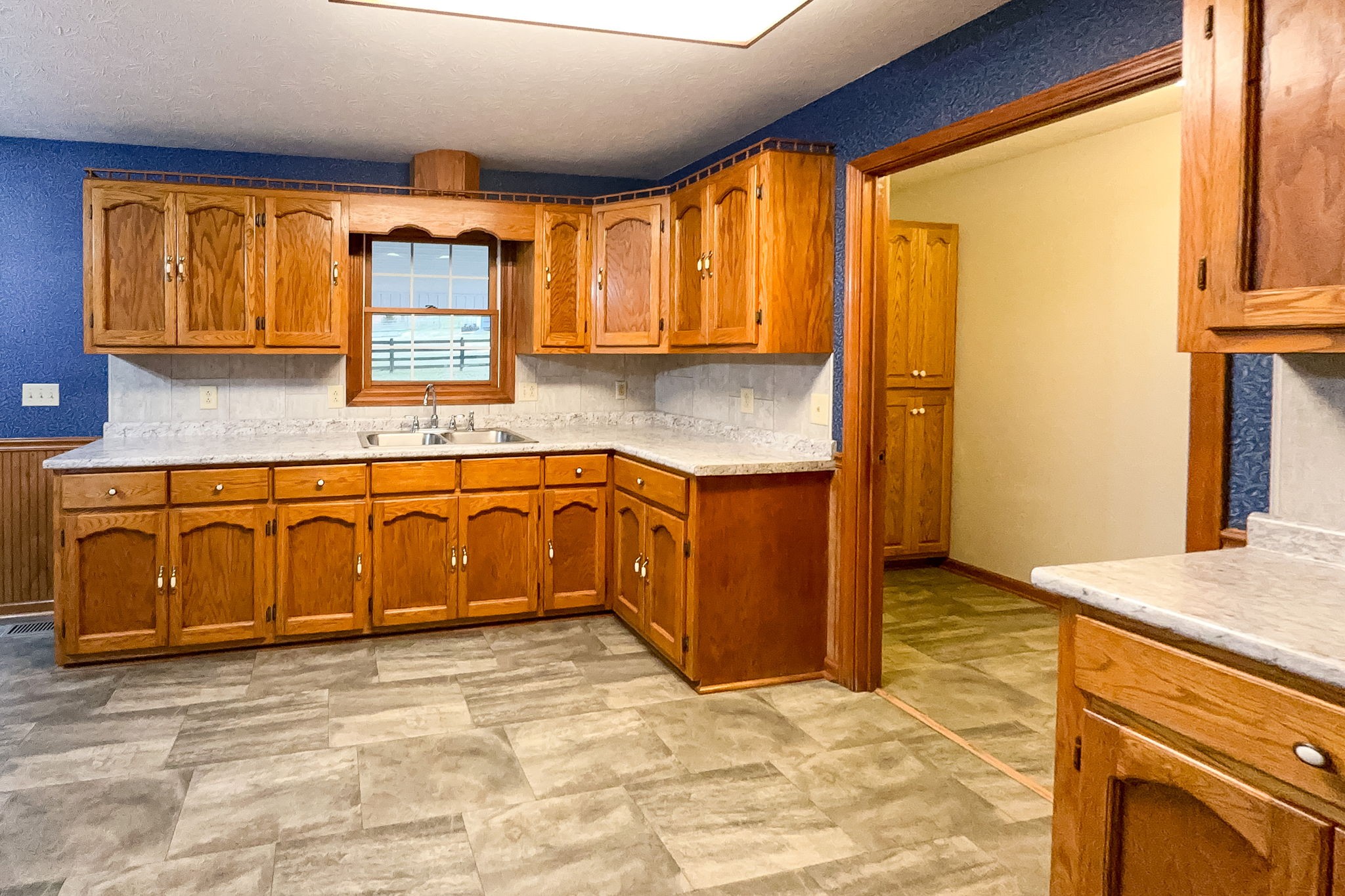 6680 Walker Creek Road Alexandria, TN 37012 - Photo 22 of 75 a kitchen with stainless steel appliances granite countertop a stove a sink and a microwave