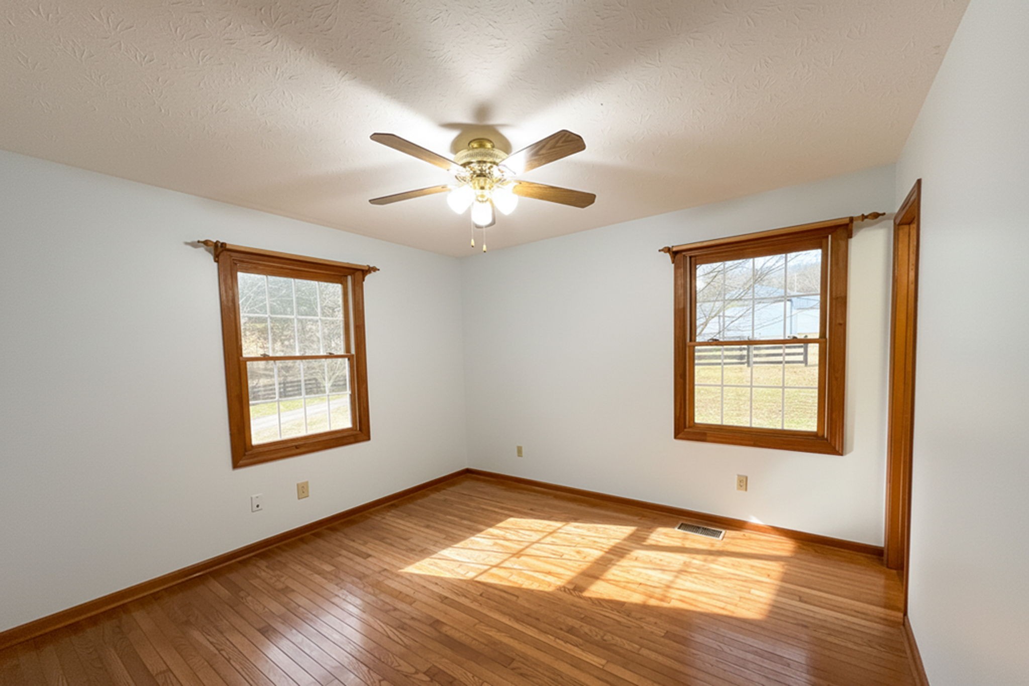 6680 Walker Creek Road Alexandria, TN 37012 - Photo 37 of 75 a view of an empty room with a window and wooden floor