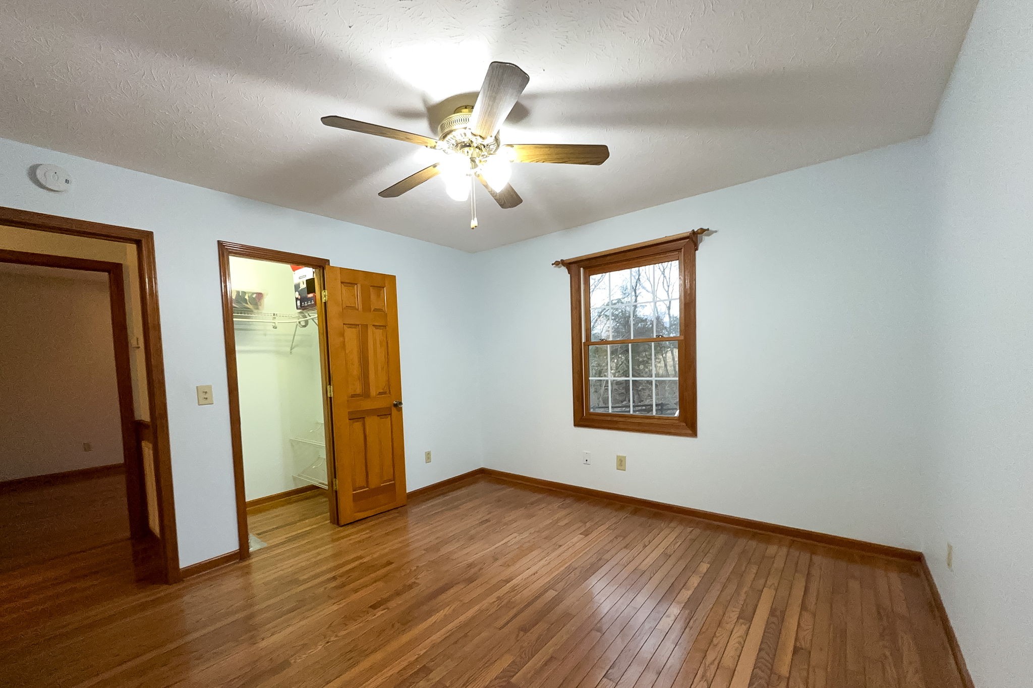6680 Walker Creek Road Alexandria, TN 37012 - Photo 44 of 75 a view of an empty room with wooden floor and a window