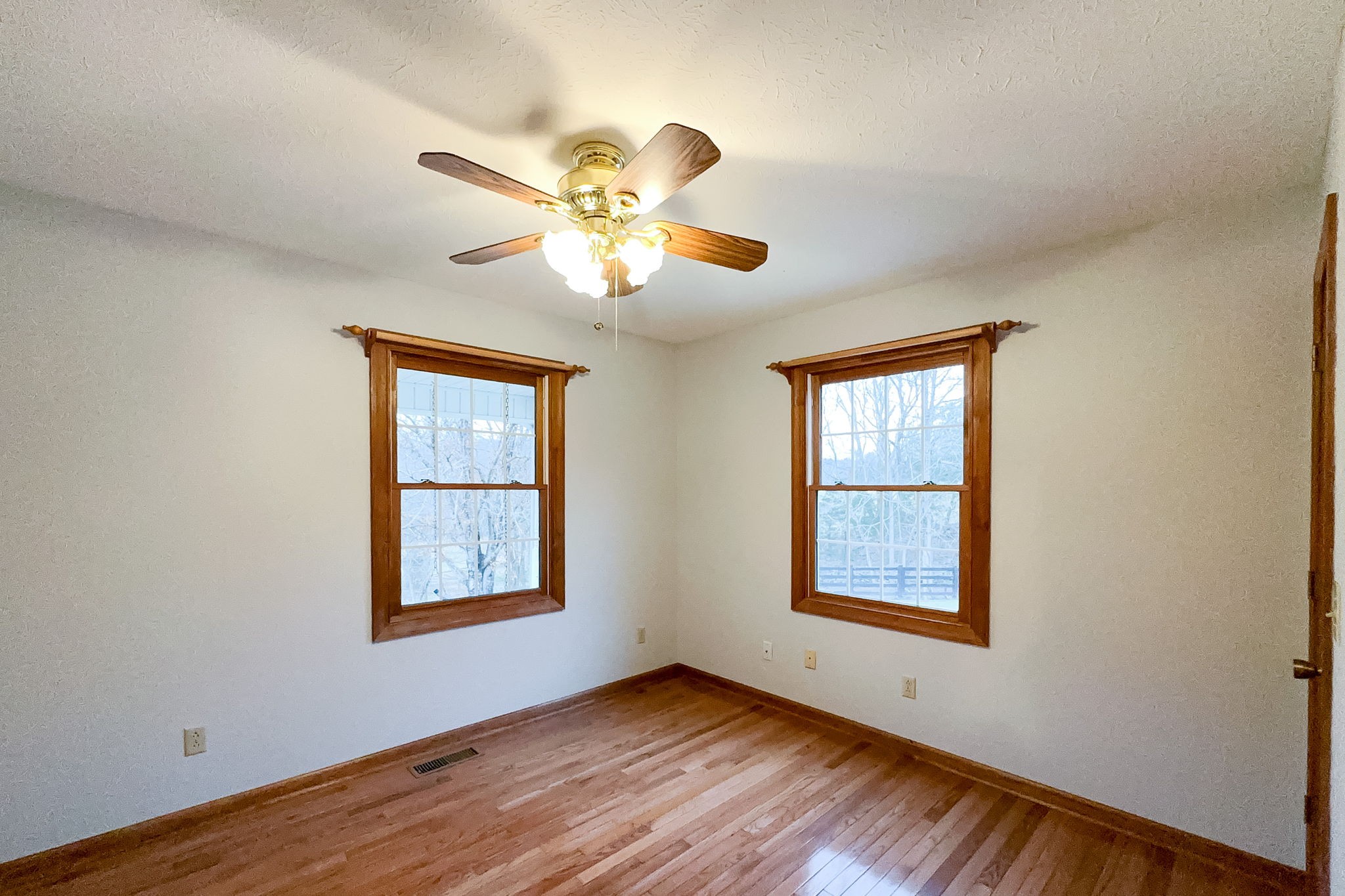 6680 Walker Creek Road Alexandria, TN 37012 - Photo 45 of 75 a view of an empty room with window and wooden floor