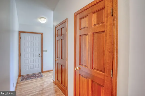 an entryway to room with wooden floor