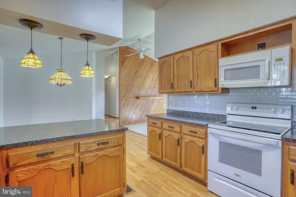 a kitchen with a refrigerator and cabinets