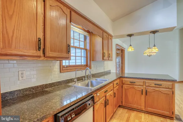 a kitchen with granite countertop a sink and cabinets