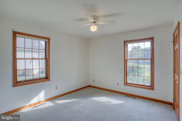 an empty room with windows and closet