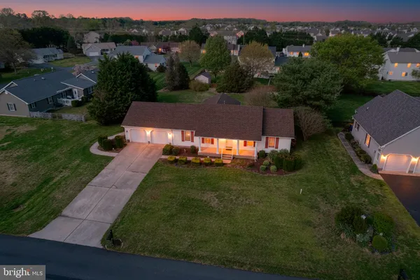 an aerial view of a house with yard