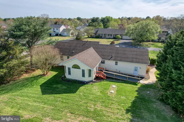 an aerial view of a house with a garden and a yard