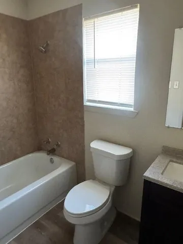 a bathroom with a toilet a sink and a bathtub