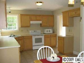 500 Crabtree Court Fort Mill, SC 29708 - Photo 3 of 8 a kitchen with a sink a stove a window cabinetry and kitchen island
