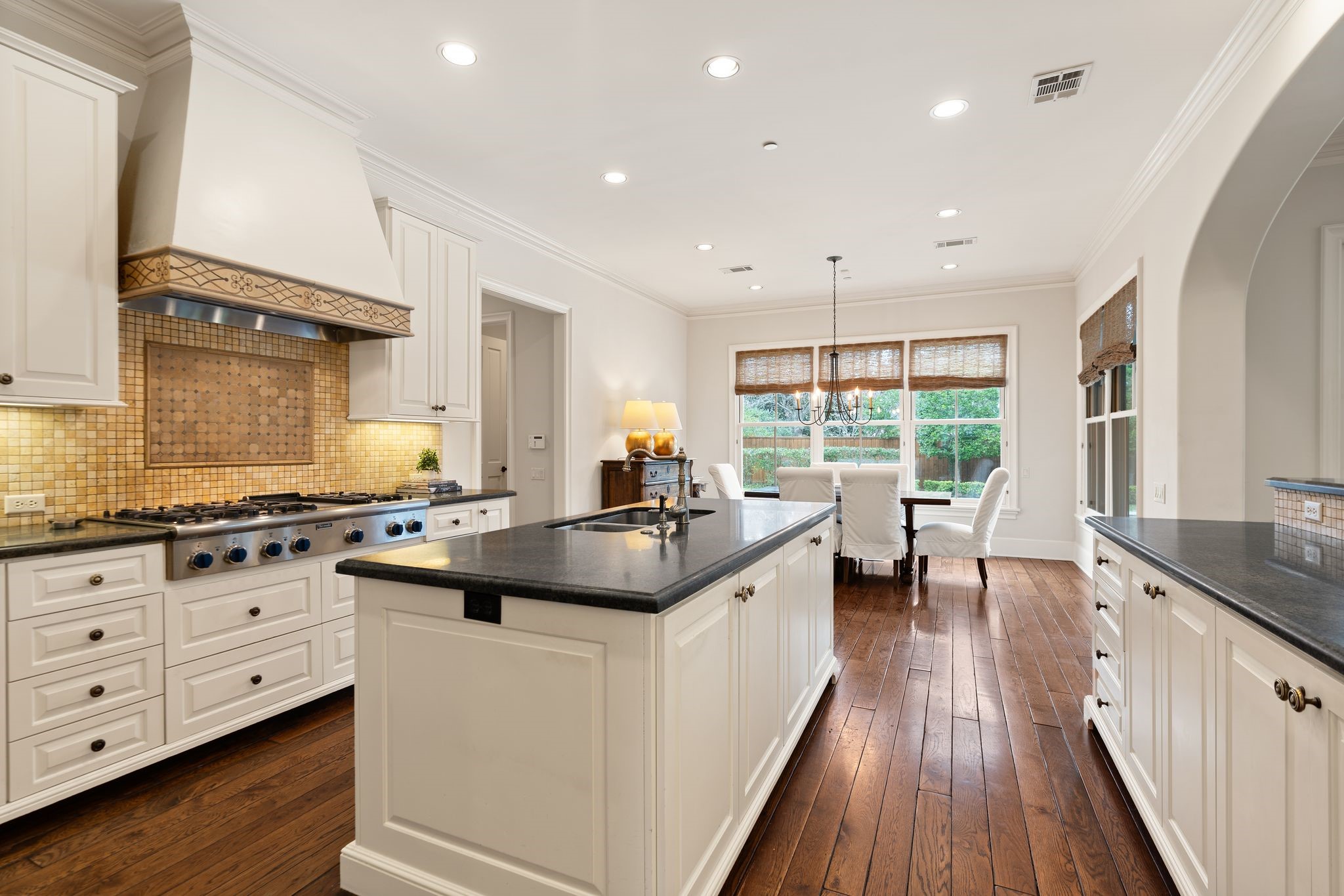 11402 Taylorcrest Road Houston, TX 77024 - Photo 12 of 44 Open sightlines connect the kitchen seamlessly to the breakfast area & family room, creating a natural gathering space at the center of the home. Ideal for both casual meals & larger-scale entertaining.