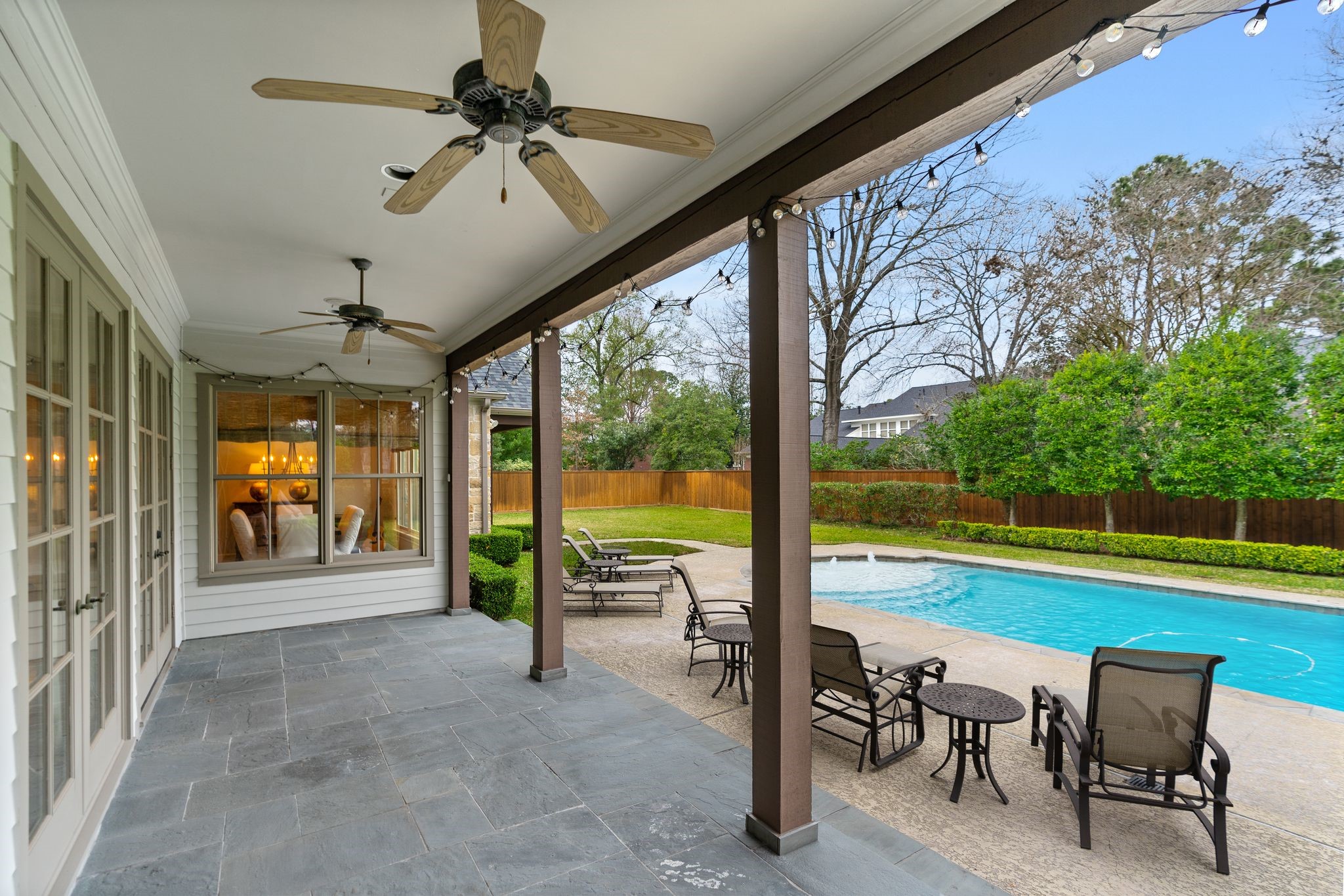 11402 Taylorcrest Road Houston, TX 77024 - Photo 41 of 44 View under the covered patio highlighting ample outdoor living space. Plenty of room to dine al fresco. Dual ceiling fans add comfort.