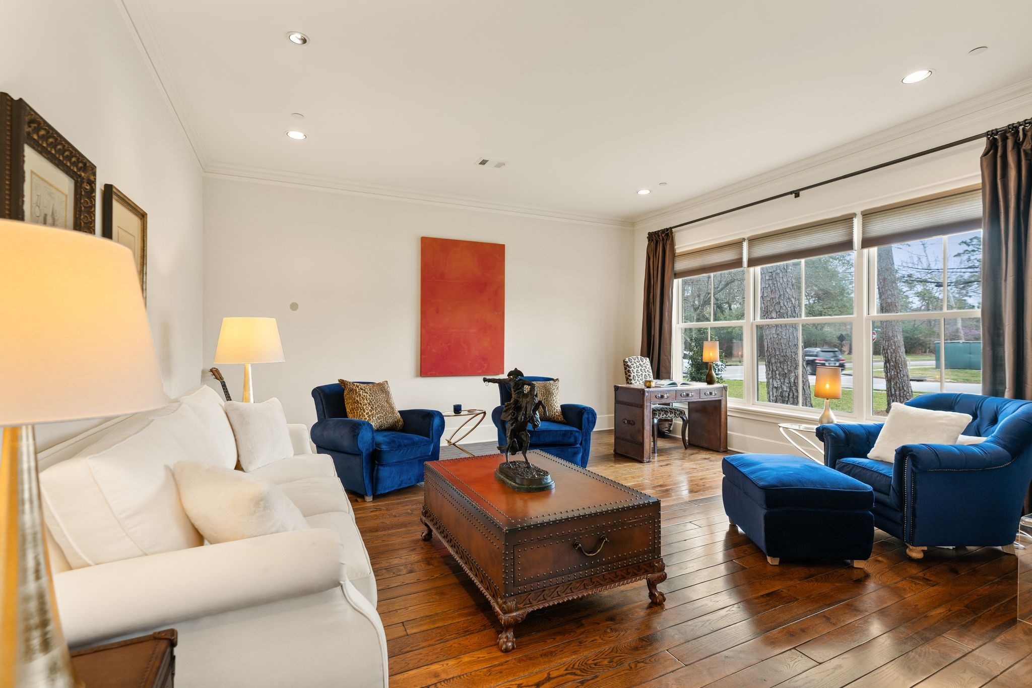 11402 Taylorcrest Road Houston, TX 77024 - Photo 9 of 44 Spacious formal living room highlighted by 10’ ceilings, crown molding, and recessed lighting. Hardwood floors and custom window coverings complete the space, offering both warmth and sophistication. A beautifully scaled room ideal for elegant entertaining or refined everyday living. Flexible room; could make an ideal home office or imagine a mahjong table next to the window!