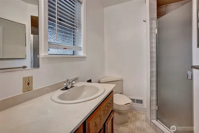a bathroom with a sink toilet and a mirror