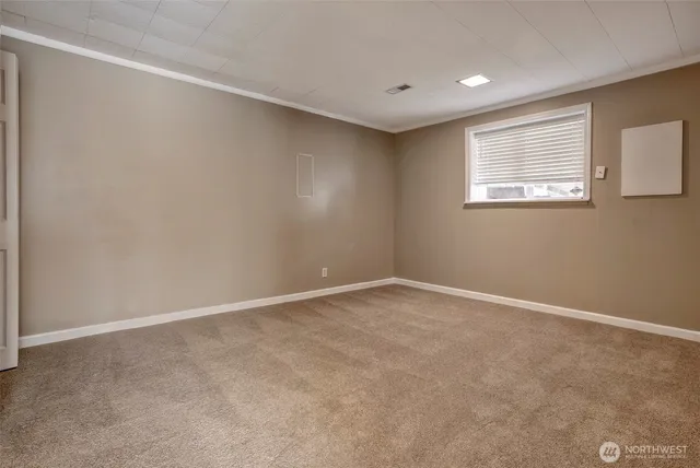 a view of an empty room with a window