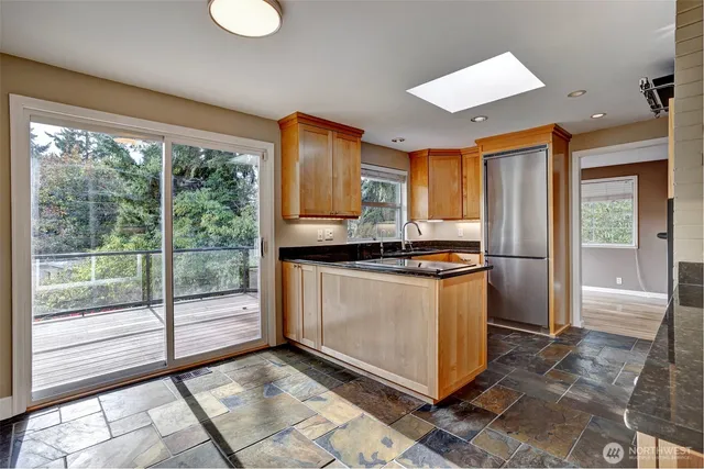 a kitchen with stainless steel appliances granite countertop a refrigerator and a sink