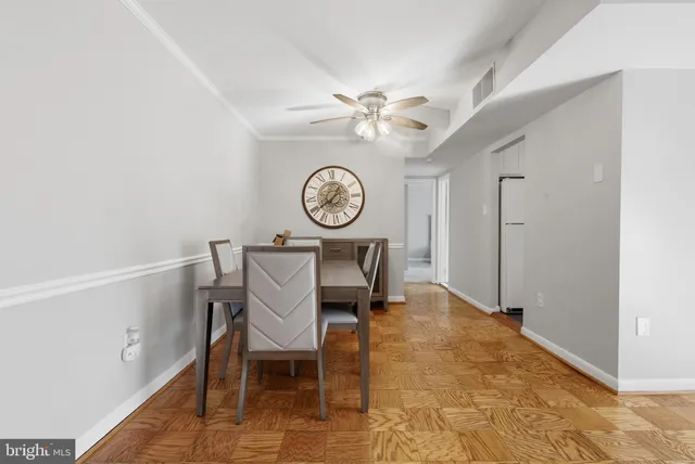 a view of a hallway with a table and a clock on the wall