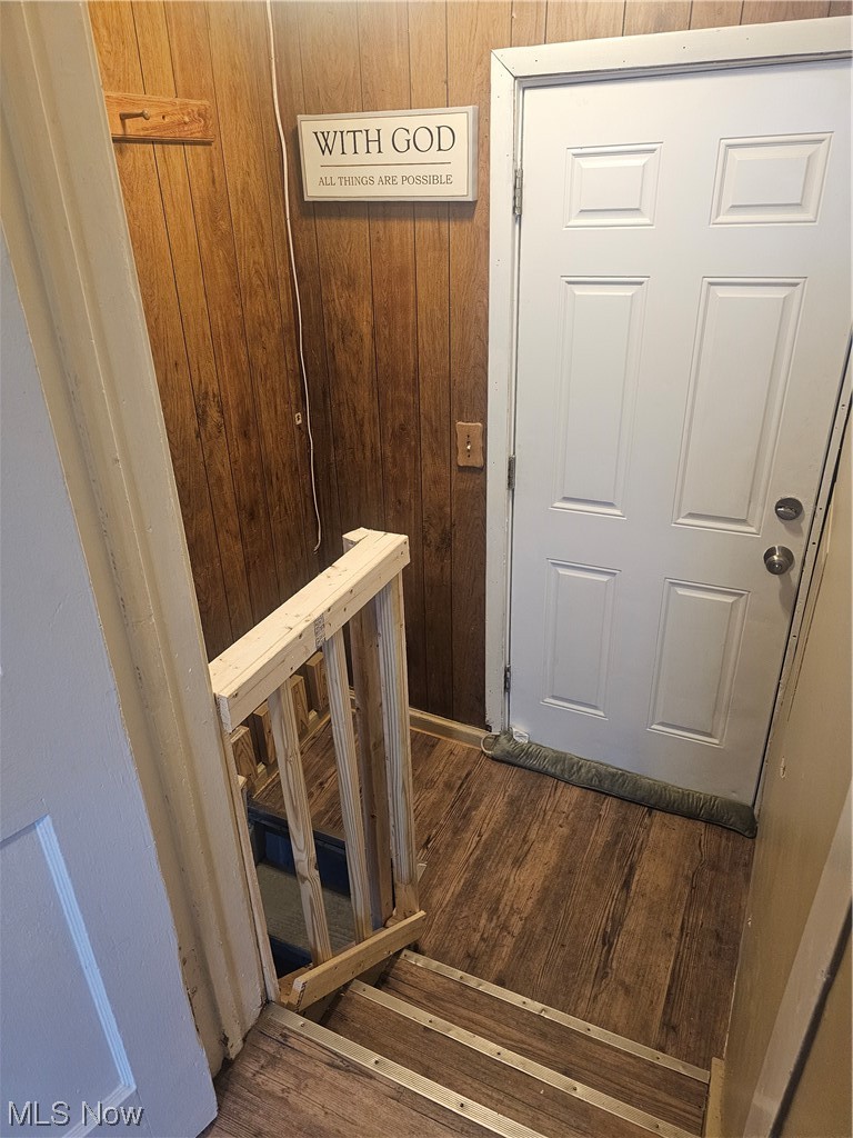 4324 Turney Road Cleveland, OH 44105 - Photo 21 of 27 Stairs featuring wood walls and dark hardwood / wood-style flooring