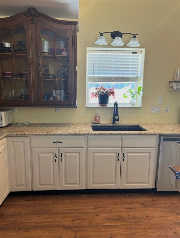 1794 Cr 527 Road Baird, TX 79504 - Photo 22 of 38 White lower cabinetry with decorative hardware, granite-look countertops, and a black sink with a matte black faucet