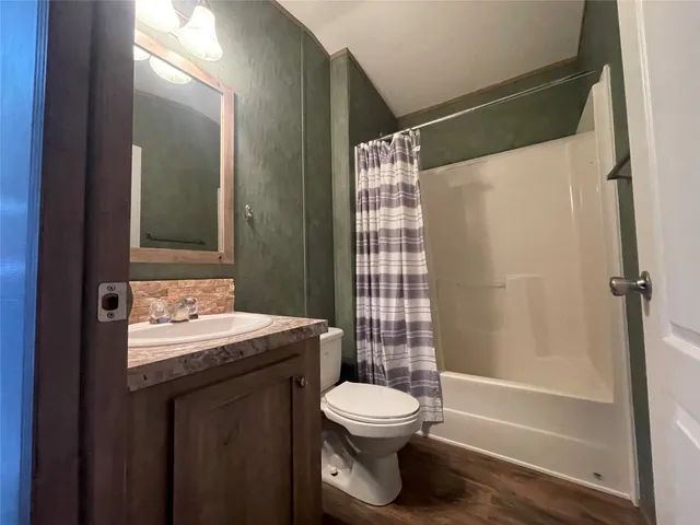 a bathroom with a toilet a sink and shower