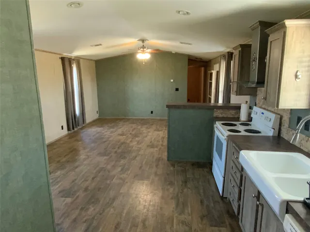 a kitchen with a sink stove and refrigerator
